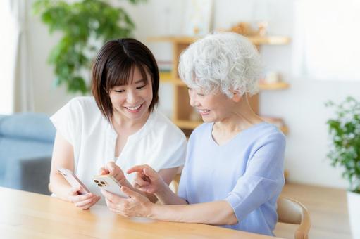 A mother and daughter keeping in touch by smartphone